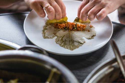 roll-stuffed-grape-leaf-after-stuffing-is-on-leaf